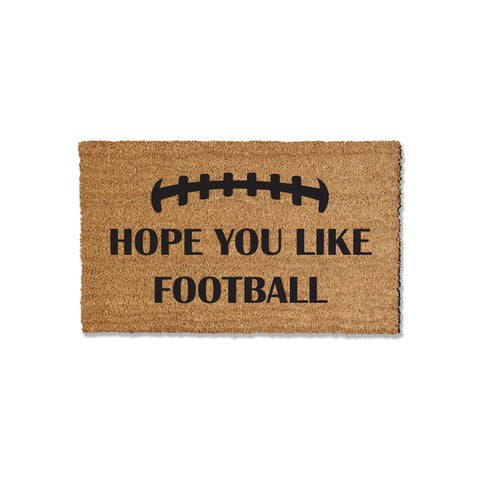 Introduce football spirit to your entryway with our 1/2-inch thick coir doormat, featuring the message 'Hope your like football.' Ideal for welcoming guests during the football season, this versatile mat is available in multiple sizes, providing a perfect blend of style and functionality for your home's entrance.
