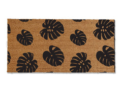 Transform your entrance with our coir doormat showcasing an all-over monstera leaf pattern. The perfect touch for a beach or tropical vibe, this stylish mat is available in multiple sizes and colors. Beyond its aesthetic appeal, it excels at trapping dirt, making it a functional and fashionable addition to enhance your entryway.