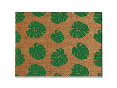 Transform your entrance with our coir doormat showcasing an all-over monstera leaf pattern. The perfect touch for a beach or tropical vibe, this stylish mat is available in multiple sizes and colors. Beyond its aesthetic appeal, it excels at trapping dirt, making it a functional and fashionable addition to enhance your entryway.