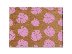 Transform your entrance with our coir doormat showcasing an all-over monstera leaf pattern. The perfect touch for a beach or tropical vibe, this stylish mat is available in multiple sizes and colors. Beyond its aesthetic appeal, it excels at trapping dirt, making it a functional and fashionable addition to enhance your entryway.
