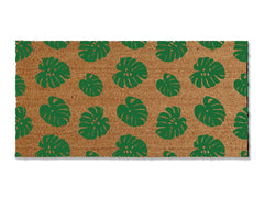 Transform your entrance with our coir doormat showcasing an all-over monstera leaf pattern. The perfect touch for a beach or tropical vibe, this stylish mat is available in multiple sizes and colors. Beyond its aesthetic appeal, it excels at trapping dirt, making it a functional and fashionable addition to enhance your entryway.
