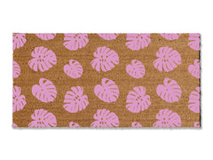 Transform your entrance with our coir doormat showcasing an all-over monstera leaf pattern. The perfect touch for a beach or tropical vibe, this stylish mat is available in multiple sizes and colors. Beyond its aesthetic appeal, it excels at trapping dirt, making it a functional and fashionable addition to enhance your entryway.