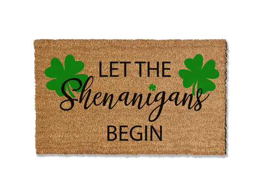 Add a touch of Irish charm to your entryway with our seasonal coir doormat featuring four-leaf clovers and the playful phrase 'Let the Shenanigans Begin.' Perfect for St. Patrick's Day, this festive design brings a whimsical flair to your doorstep. Available in multiple sizes, the mat is not only delightful but also effective at trapping dirt.