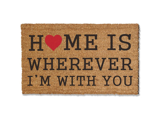 Add warmth to your entryway with our coir doormat bearing the phrase 'Home is Wherever I'm With You.' This sentiment serves as a heartfelt reminder of what truly matters, all while effectively keeping dirt at bay. Welcome guests with this charming and meaningful addition to your home.