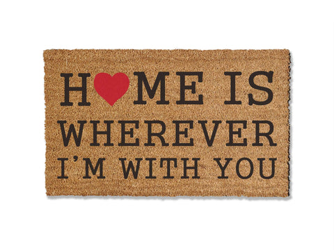 Add warmth to your entryway with our coir doormat bearing the phrase 'Home is Wherever I'm With You.' This sentiment serves as a heartfelt reminder of what truly matters, all while effectively keeping dirt at bay. Welcome guests with this charming and meaningful addition to your home.