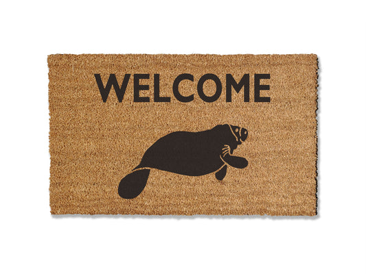 Welcome guests with our adorable coir doormat featuring a charming manatee design. Available in multiple sizes, this delightful mat not only adds a touch of sea-loving charm to your entryway but is also highly effective at trapping dirt. Spread love for these cute sea cows and enhance your doorstep with this functional and whimsical coir doormat.