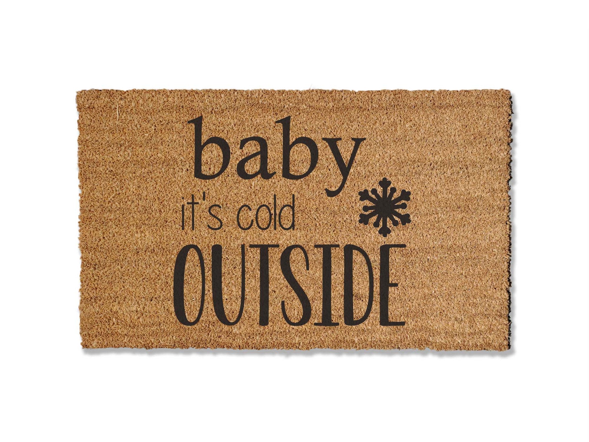 A coir doormat that is 18 inches by 30 inches and has a the text baby it's cold outside with a snowflake painted on it.