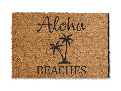 24 inches by 36 inches coir doormat with graphic printed onto the doormat. Aloha Beaches with palm trees
