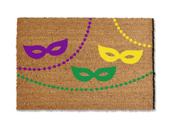 Bring the spirit of Mardi Gras to your doorstep with our festive coir doormat adorned with colorful masks and beads. Perfect for the celebration, this vibrant mat adds a touch of carnival flair to your entryway.