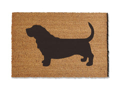 A coir doormat that is 24 inches by 36 inches and has the silhouette of a basset hound painted on it.