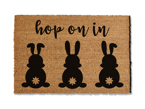 Welcome guests with our festive seasonal coir doormat, saying 'Hop on In' and featuring three adorable bunnies. The perfect way to greet guests this Easter, this mat not only adds a touch of holiday cheer but also excels at trapping dirt to keep it from entering your home.