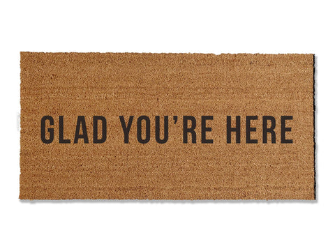 Extend a warm welcome with our 'GLAD YOU'RE HERE' coir doormat, available in various sizes. Perfect for both function and style, this charming mat invites guests into your home while effectively keeping dirt at bay. Choose the ideal size to enhance your entryway.